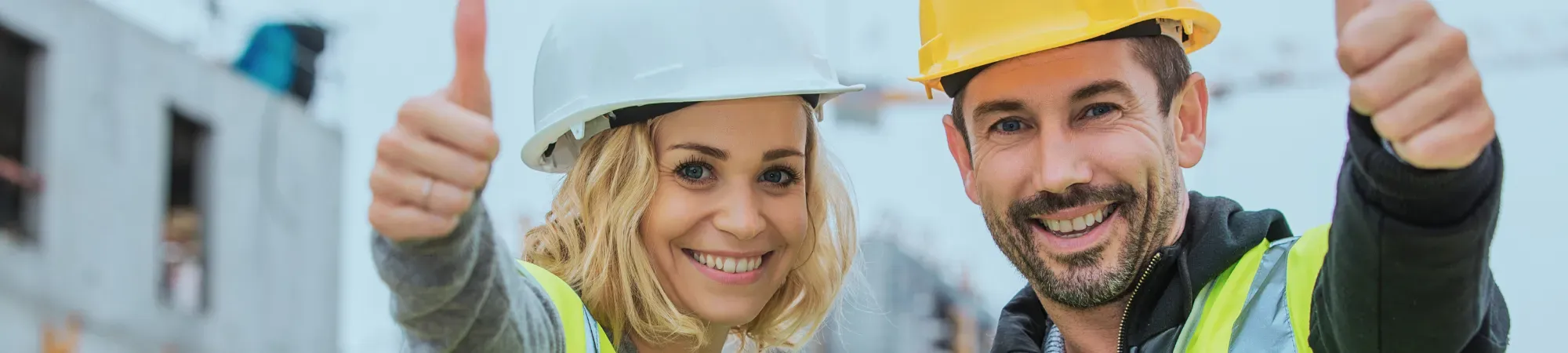 Two construction workers with their thumbs up 